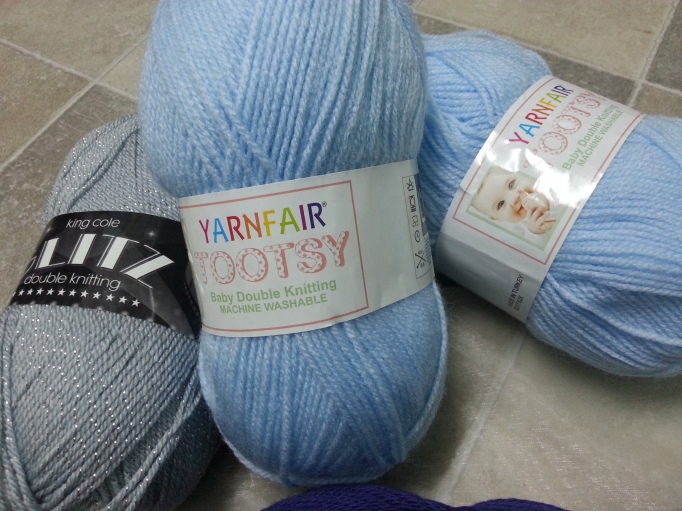 one ball of king cole glitz in silver and two balls of light blue dk baby yarn